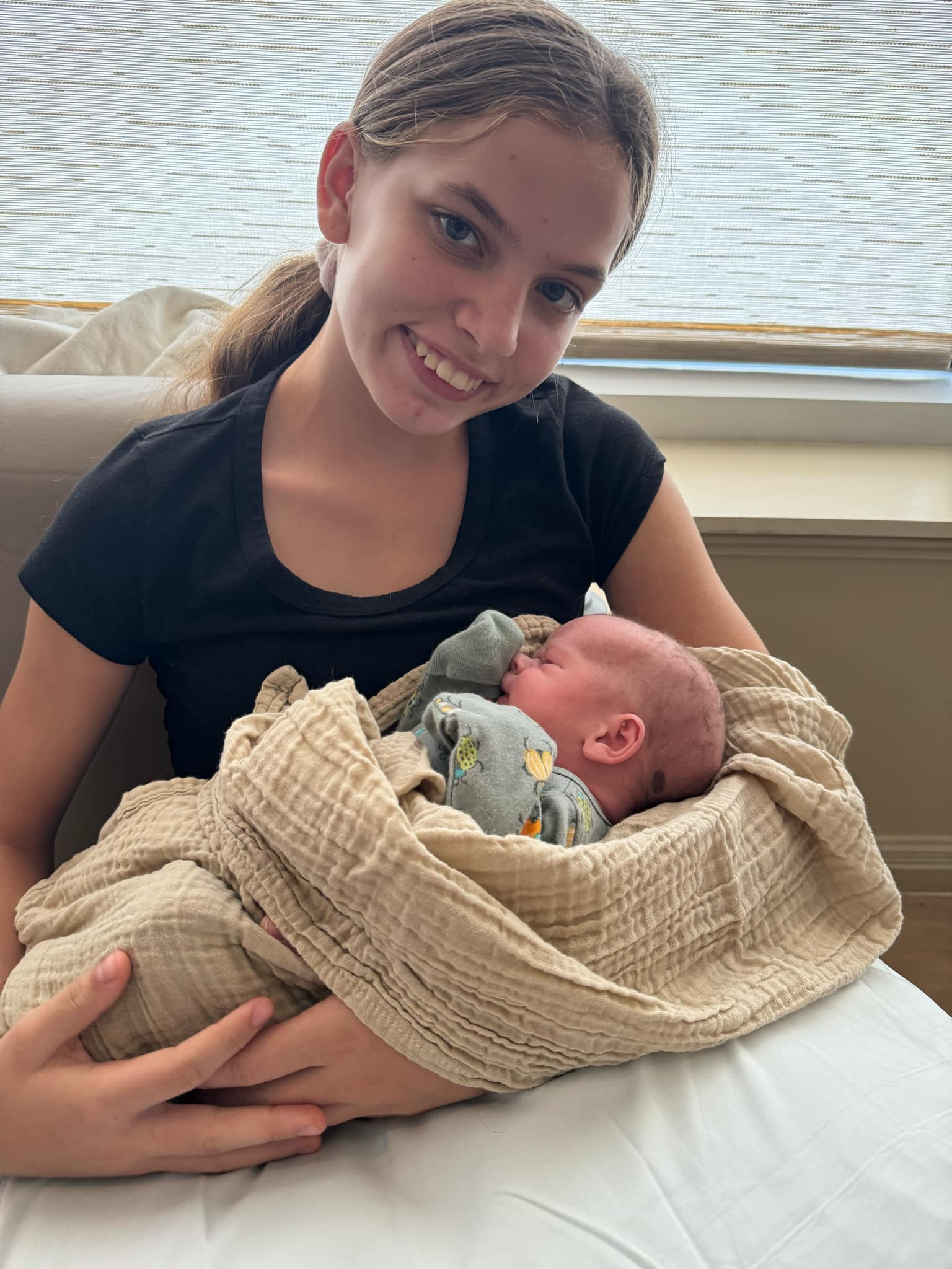 Photo of big sister Mackenzie holding baby Jackson